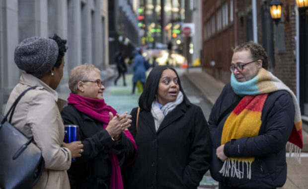 A group of four people talking
