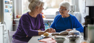 two women sitting at kitchen table