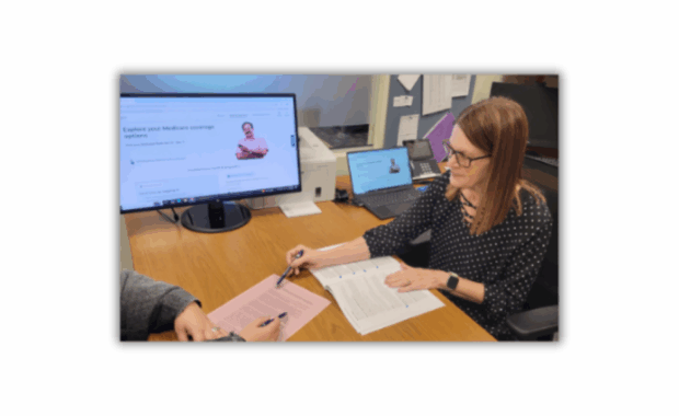 Woman pointing to information on a piece of paper in front of her.