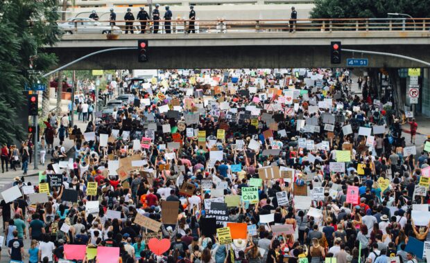 A large group of peaceful protesters fill a street