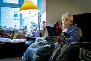woman sitting in chair reading a book