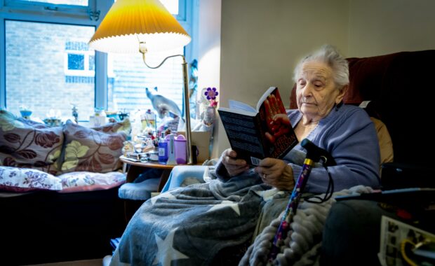 woman sitting in chair reading a book
