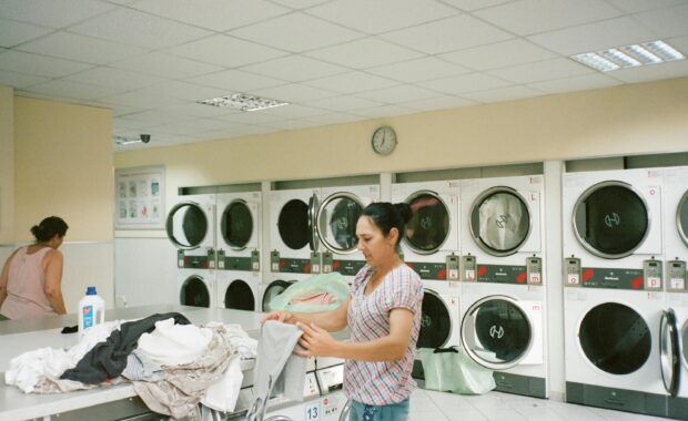 Woman doing laundry in laundromat