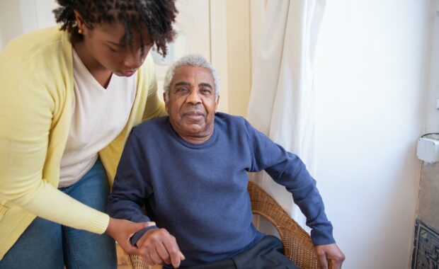 woman lifting man out of chair